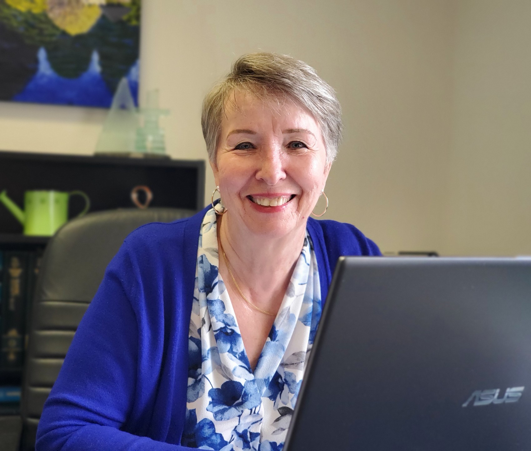 Janice smiling at her desk